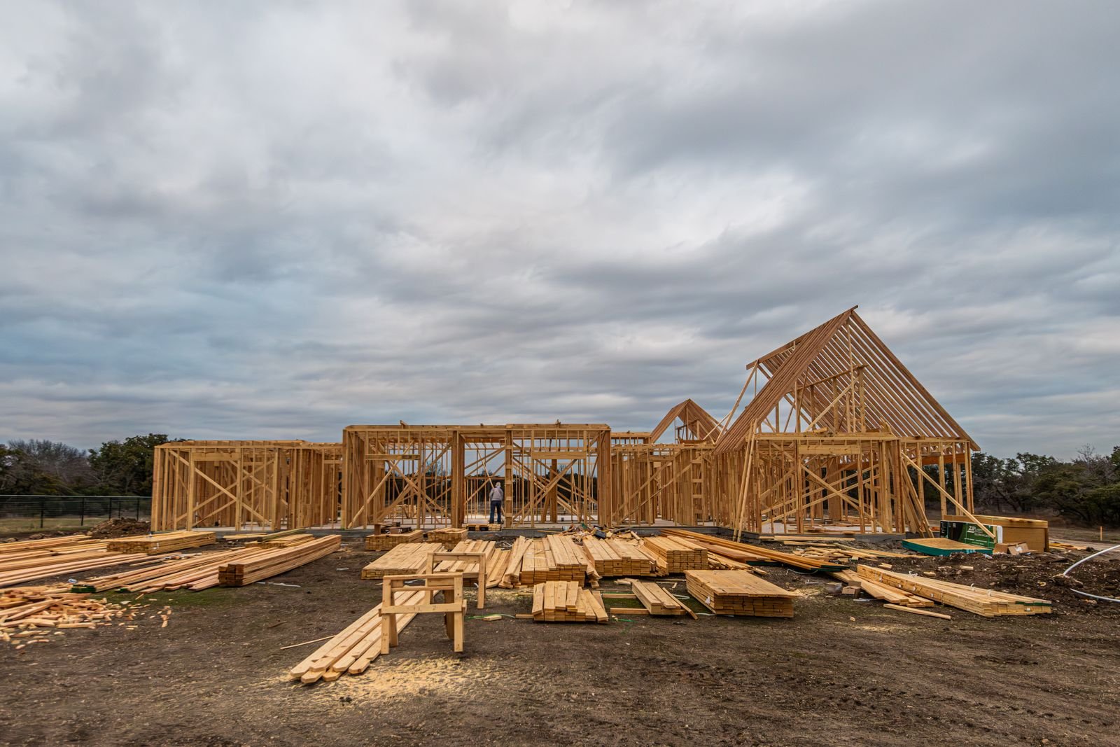 Wooden house frame under construction on a job site