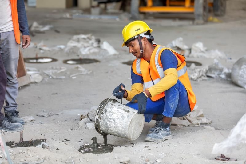 Worker pouring concrete on site